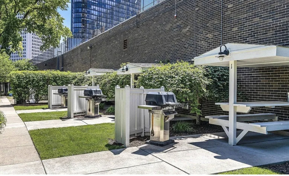 5455 North Sheridan Road, Unit 1807 Chicago, IL 60640 - Photo 10 of 10 a view of a patio with table and chairs under an umbrella