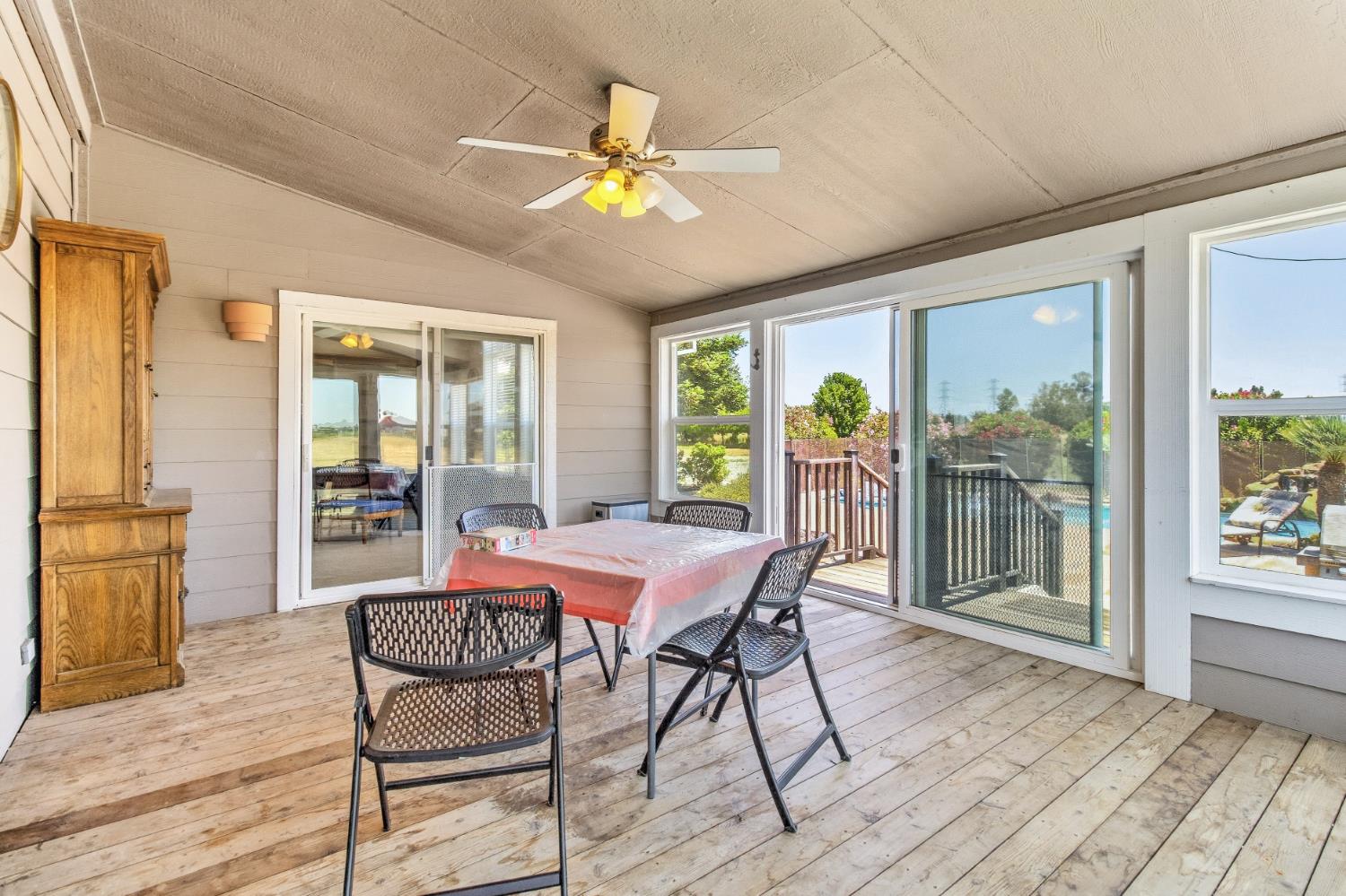 12390 Hobday Road Wilton, CA 95693 - Photo 43 of 92 a view of a dining room with furniture large windows and wooden floor