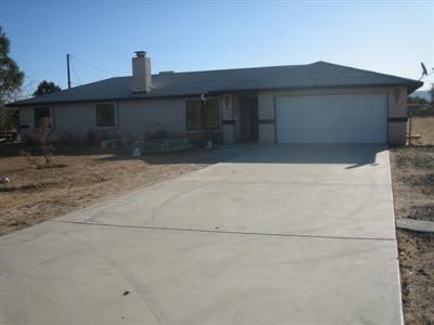 13775 Iroquois Road Apple Valley, CA 92307 - Photo 1 of 1 a front view of a house with garage