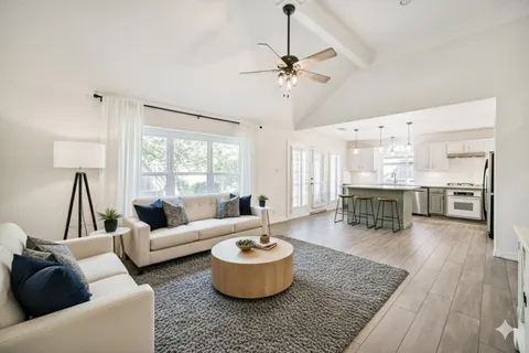 a living room with furniture and wooden floor