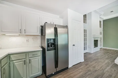 a kitchen with stainless steel appliances white cabinets and a refrigerator