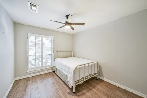a bedroom with a bed and window