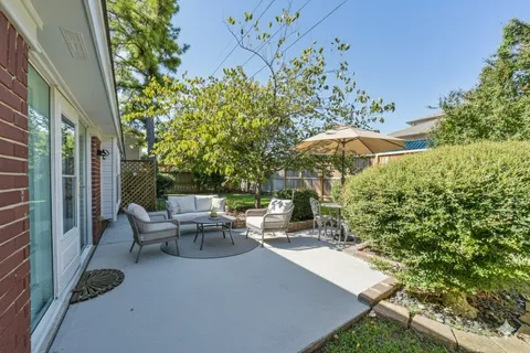 a view of backyard with patio