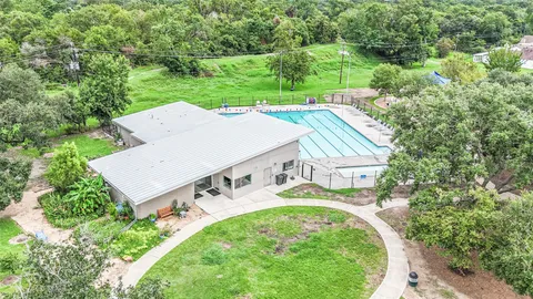 an aerial view of a house with garden space and street view