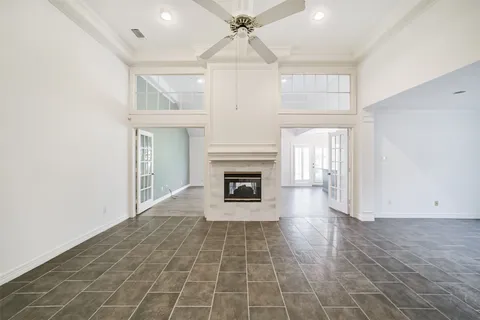 an empty room with fireplace and windows