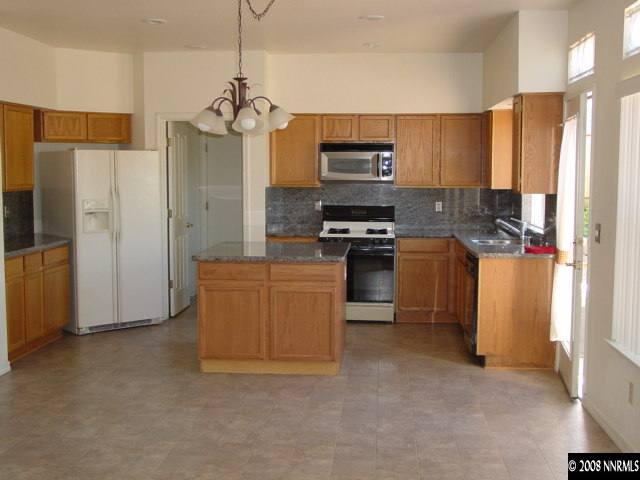 455 Snowmass Court Reno, NV 89511 - Photo 2 of 9 a kitchen with stainless steel appliances granite countertop a refrigerator a stove a sink and a refrigerator