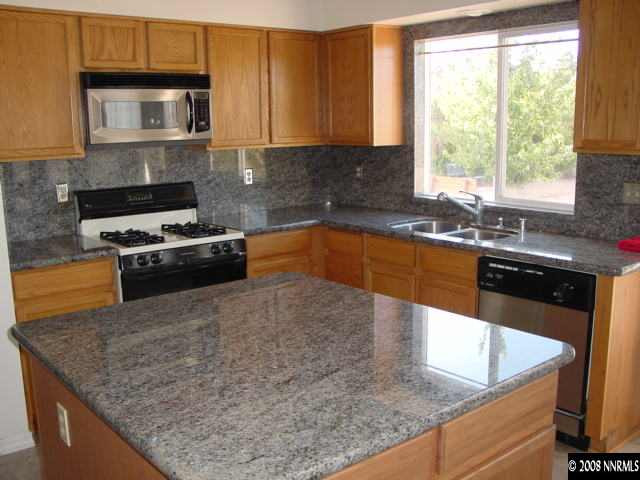 455 Snowmass Court Reno, NV 89511 - Photo 3 of 9 a kitchen with stainless steel appliances granite countertop a sink stove and microwave