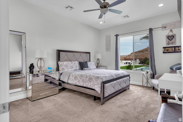 6105 Bunda Way St. George, UT 84790 - Photo 17 of 49 Carpeted bedroom featuring a large window, vaulted ceiling, and recessed lighting