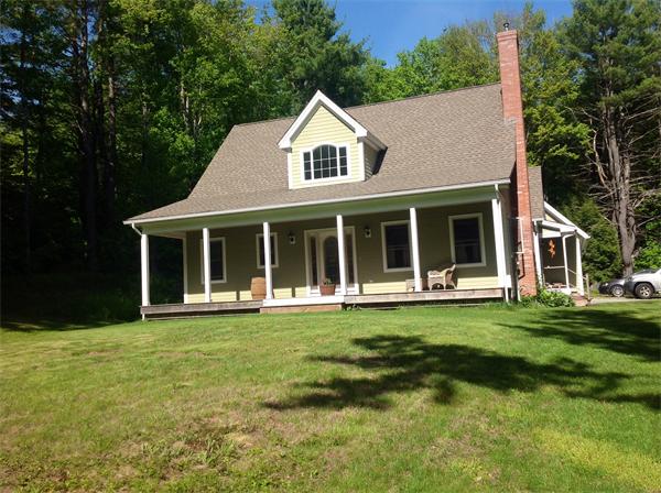 82 Shaw Road Goshen, MA 01330 - Photo 1 of 29 a front view of a house with a garden