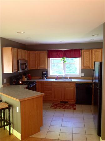 82 Shaw Road Goshen, MA 01330 - Photo 16 of 29 a kitchen with stainless steel appliances a stove sink and cabinets