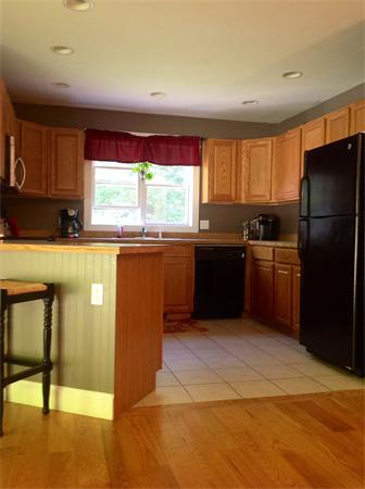 82 Shaw Road Goshen, MA 01330 - Photo 17 of 29 a kitchen with granite countertop a refrigerator and a sink