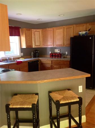 82 Shaw Road Goshen, MA 01330 - Photo 18 of 29 a kitchen with a table chairs refrigerator and window