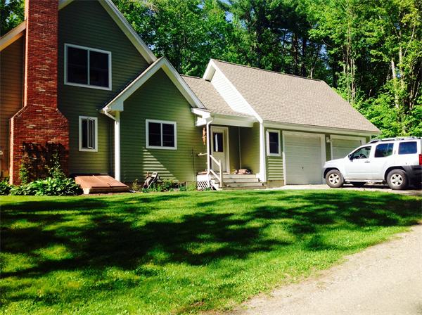 82 Shaw Road Goshen, MA 01330 - Photo 6 of 29 a front view of a house with a garden