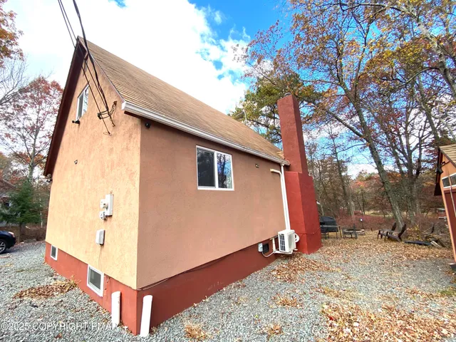 a backyard of a house with a tree