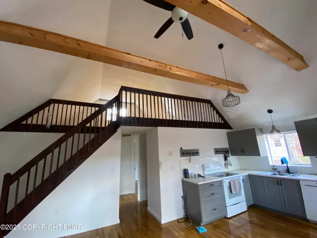 a view of kitchen with sink microwave and stove