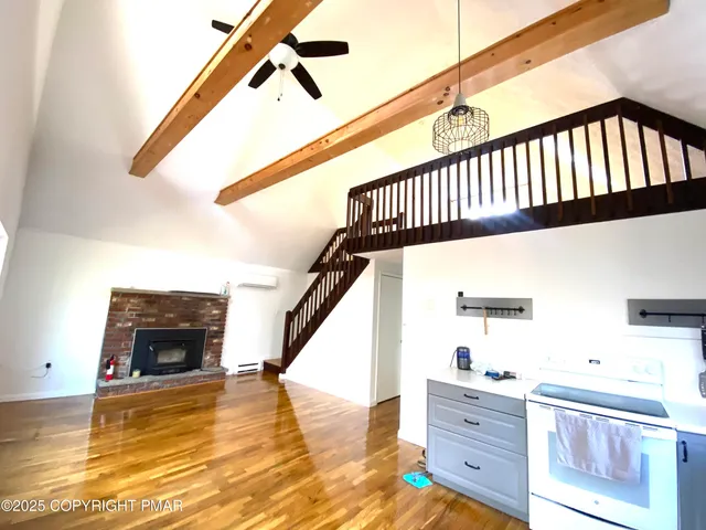 a view of a livingroom with furniture and stairs