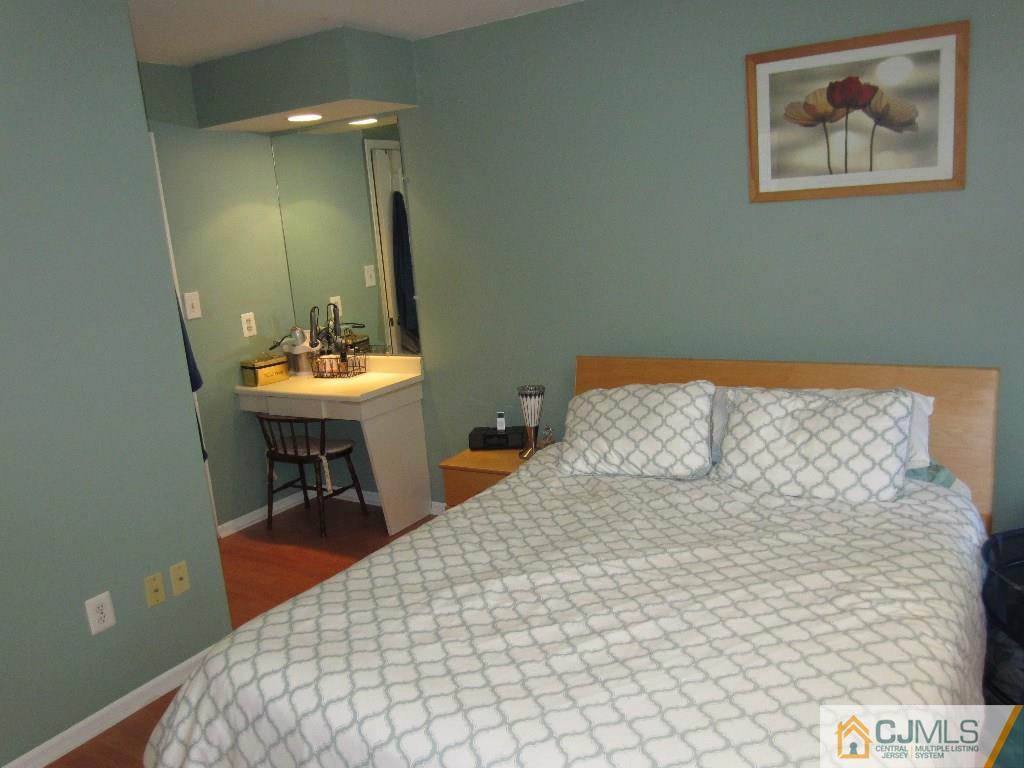 2201 Timber Oaks Road Edison, NJ 08820 - Photo 11 of 12 a bedroom with a bed and a table in it