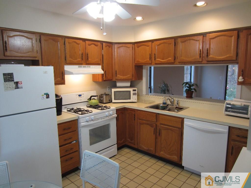 2201 Timber Oaks Road Edison, NJ 08820 - Photo 3 of 12 a kitchen with a sink a stove and refrigerator