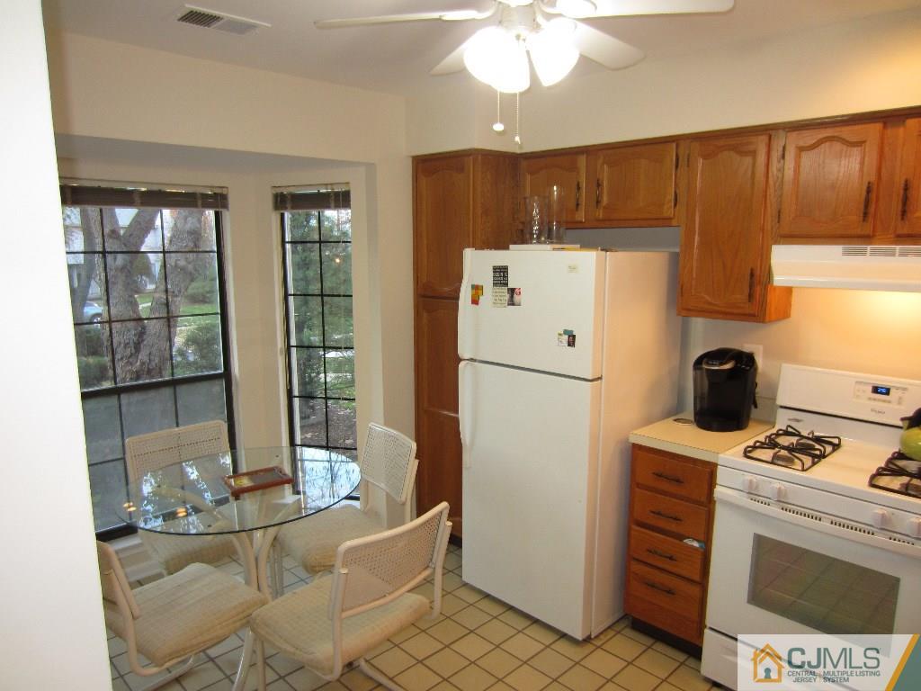 2201 Timber Oaks Road Edison, NJ 08820 - Photo 4 of 12 a kitchen with refrigerator cabinets and table