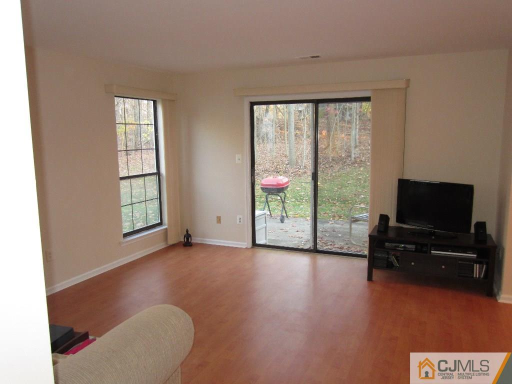 2201 Timber Oaks Road Edison, NJ 08820 - Photo 7 of 12 a living room with furniture and a flat screen tv