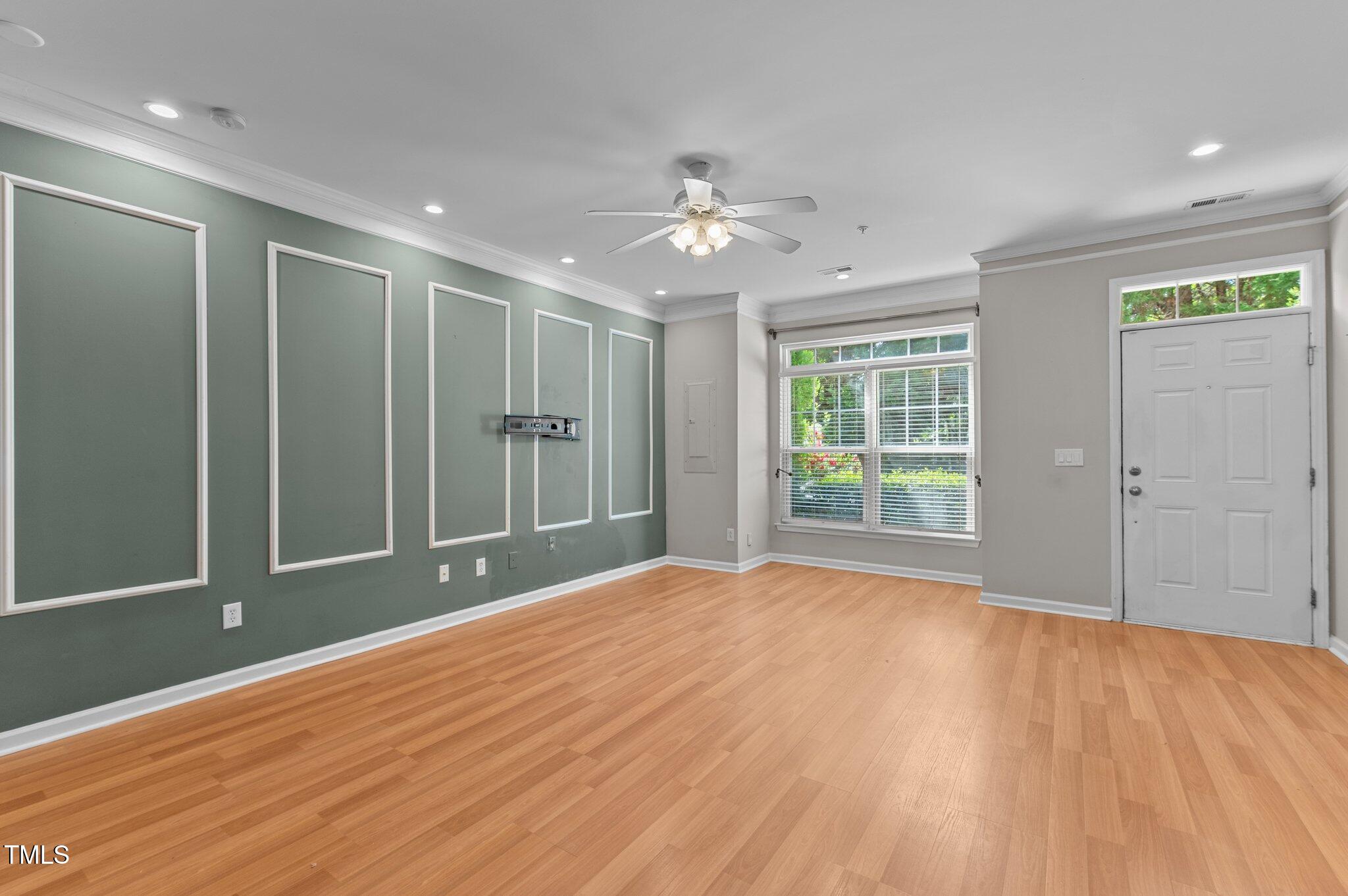 2210 Raven Road, Unit 105 Raleigh, NC 27614 - Photo 5 of 26 a view of empty room with wooden floor and fan