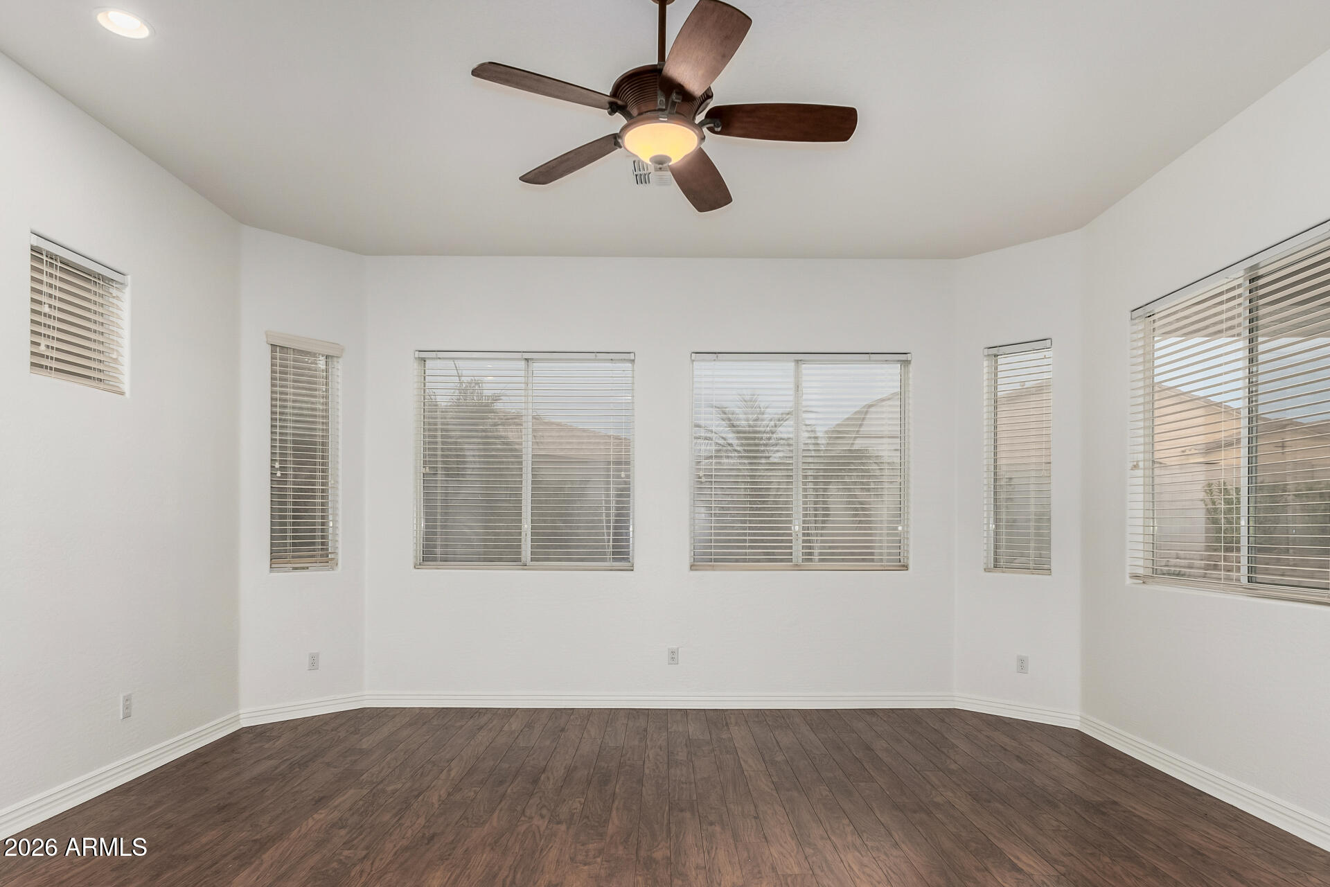 9638 West Bajada Road Peoria, AZ 85383 - Photo 12 of 26 a view of an empty room with wooden floor and a window