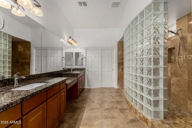 an empty room with wooden floor and chandelier fan