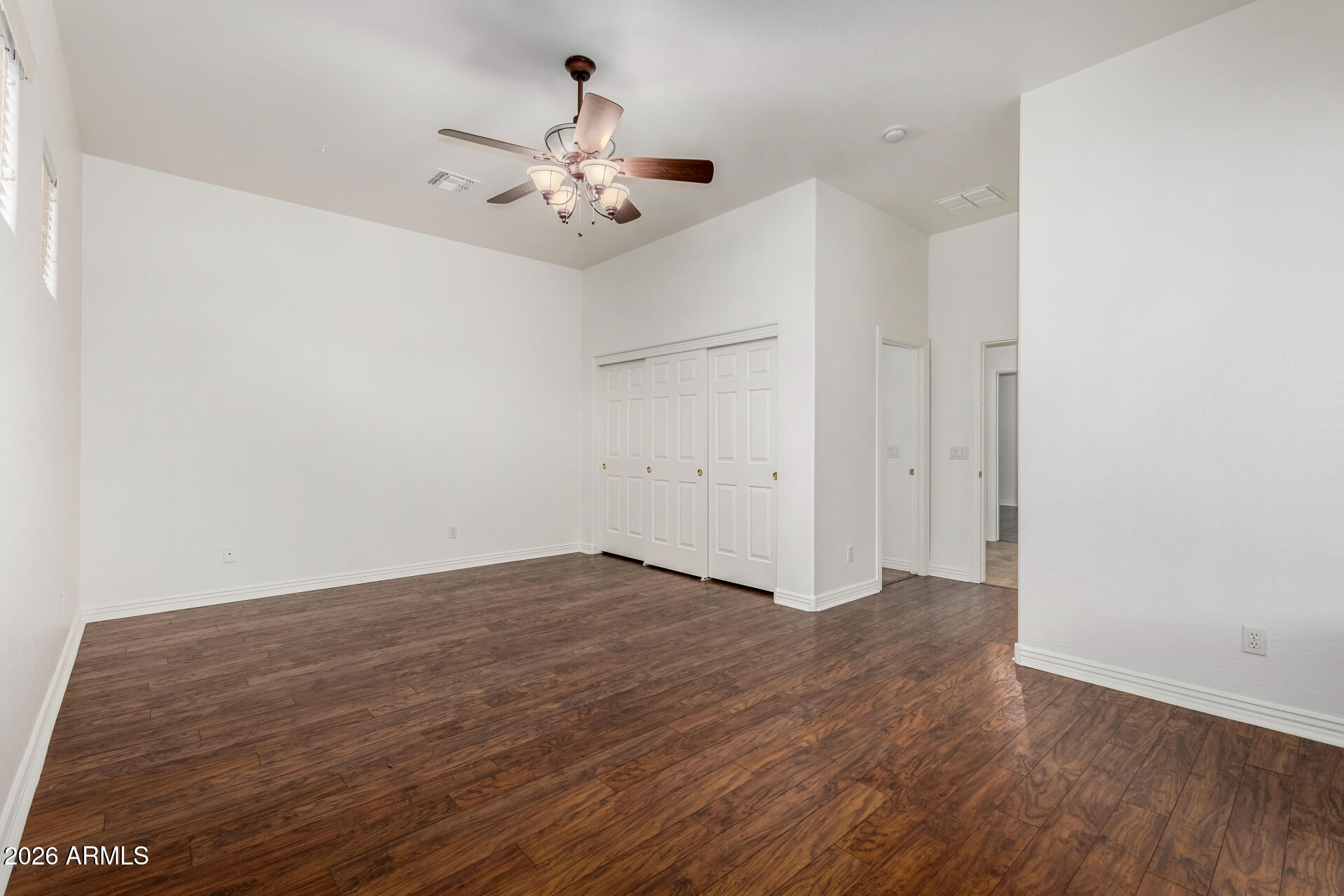 9638 West Bajada Road Peoria, AZ 85383 - Photo 14 of 26 an empty room with wooden floor and chandelier fan