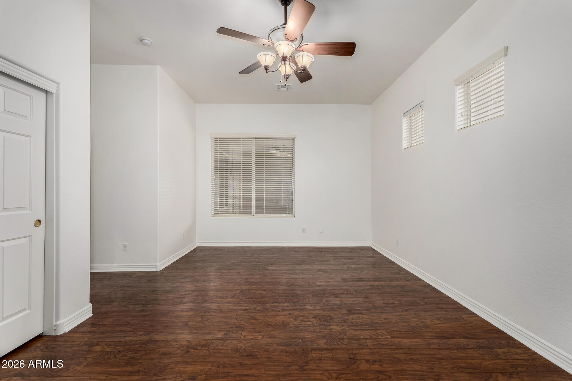 9638 West Bajada Road Peoria, AZ 85383 - Photo 15 of 26 a view of an empty room with a window and wooden floor