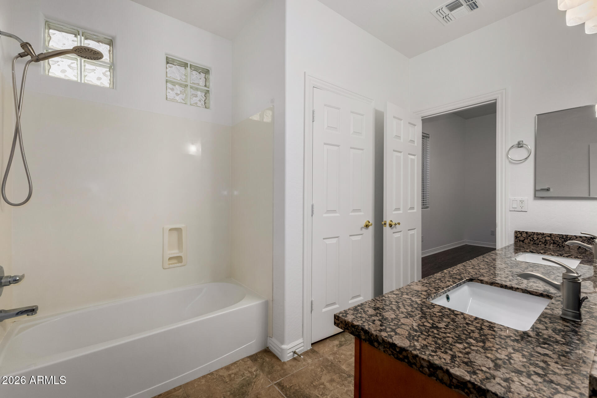 9638 West Bajada Road Peoria, AZ 85383 - Photo 17 of 26 a bathroom with a granite countertop sink and a mirror