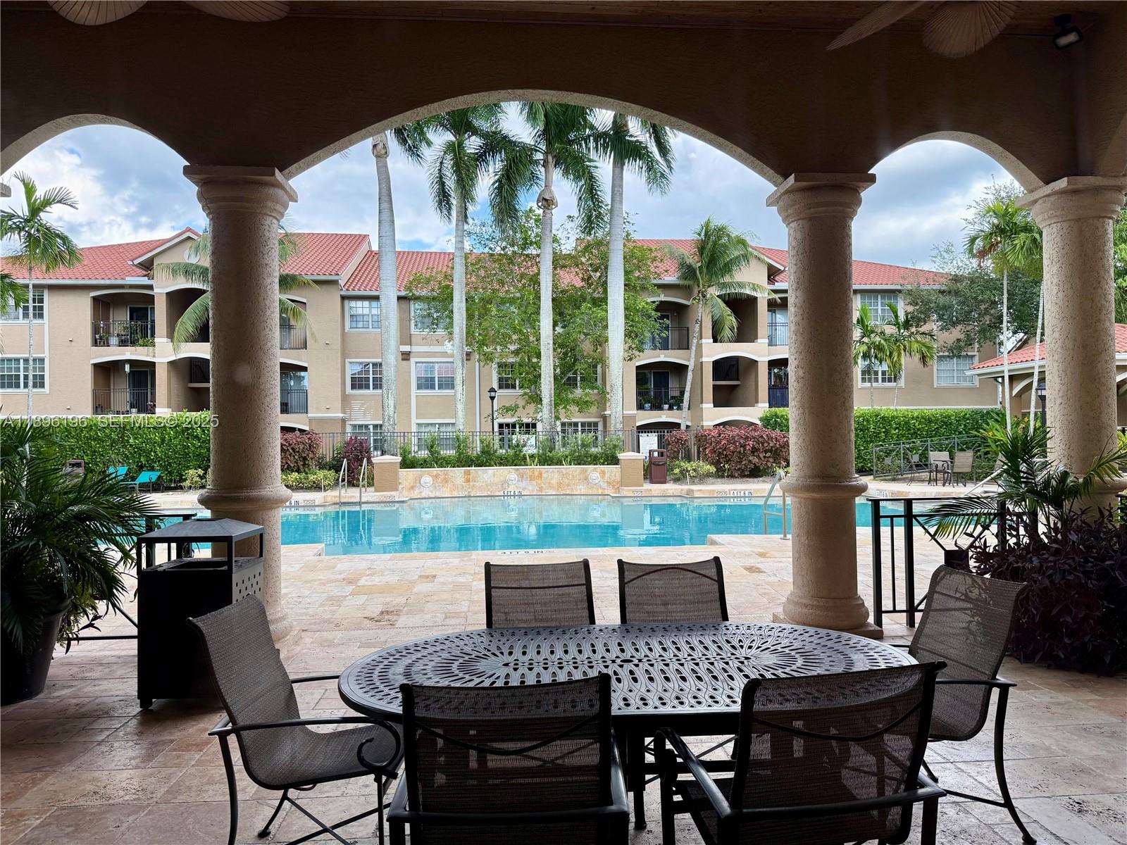 11601 Southwest 2nd Street, Unit 21301 Pembroke Pines, FL 33025 - Photo 1 of 21 a view of a dining room with furniture window and outside view