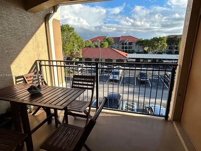 a view of a balcony with an outdoor seating