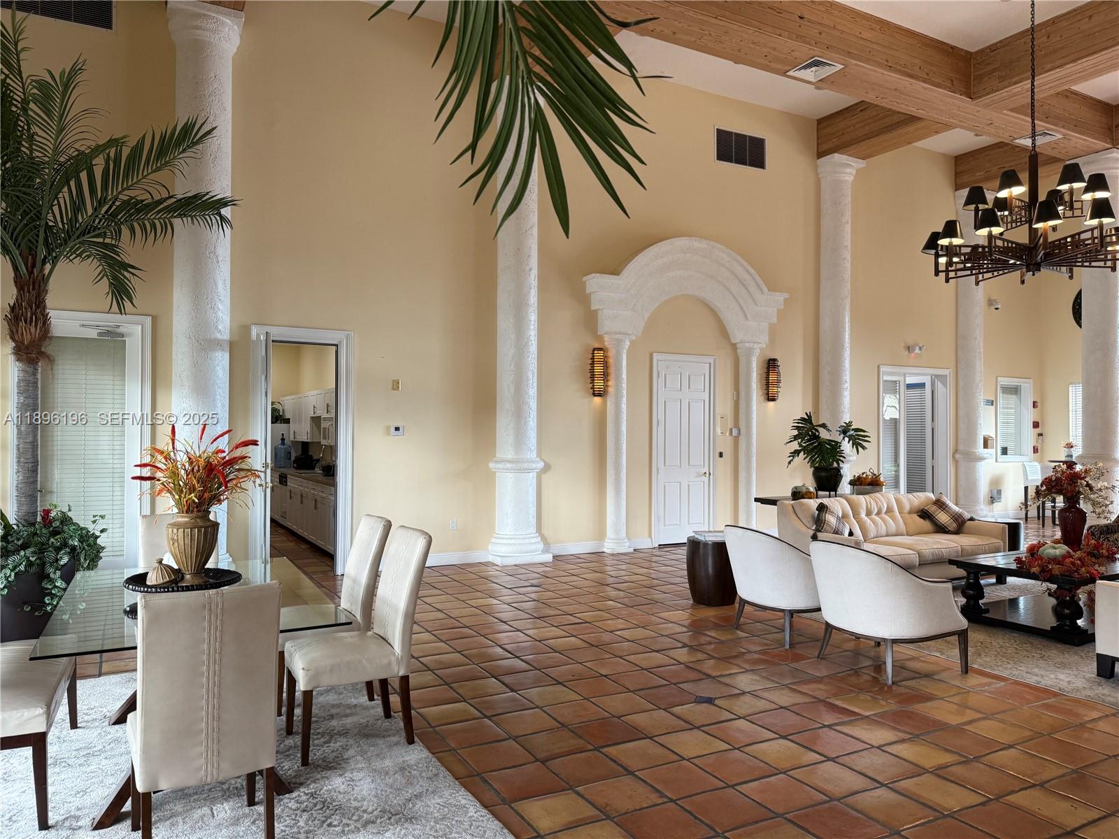 11601 Southwest 2nd Street, Unit 21301 Pembroke Pines, FL 33025 - Photo 13 of 21 a living room with furniture a chandelier and a dining table