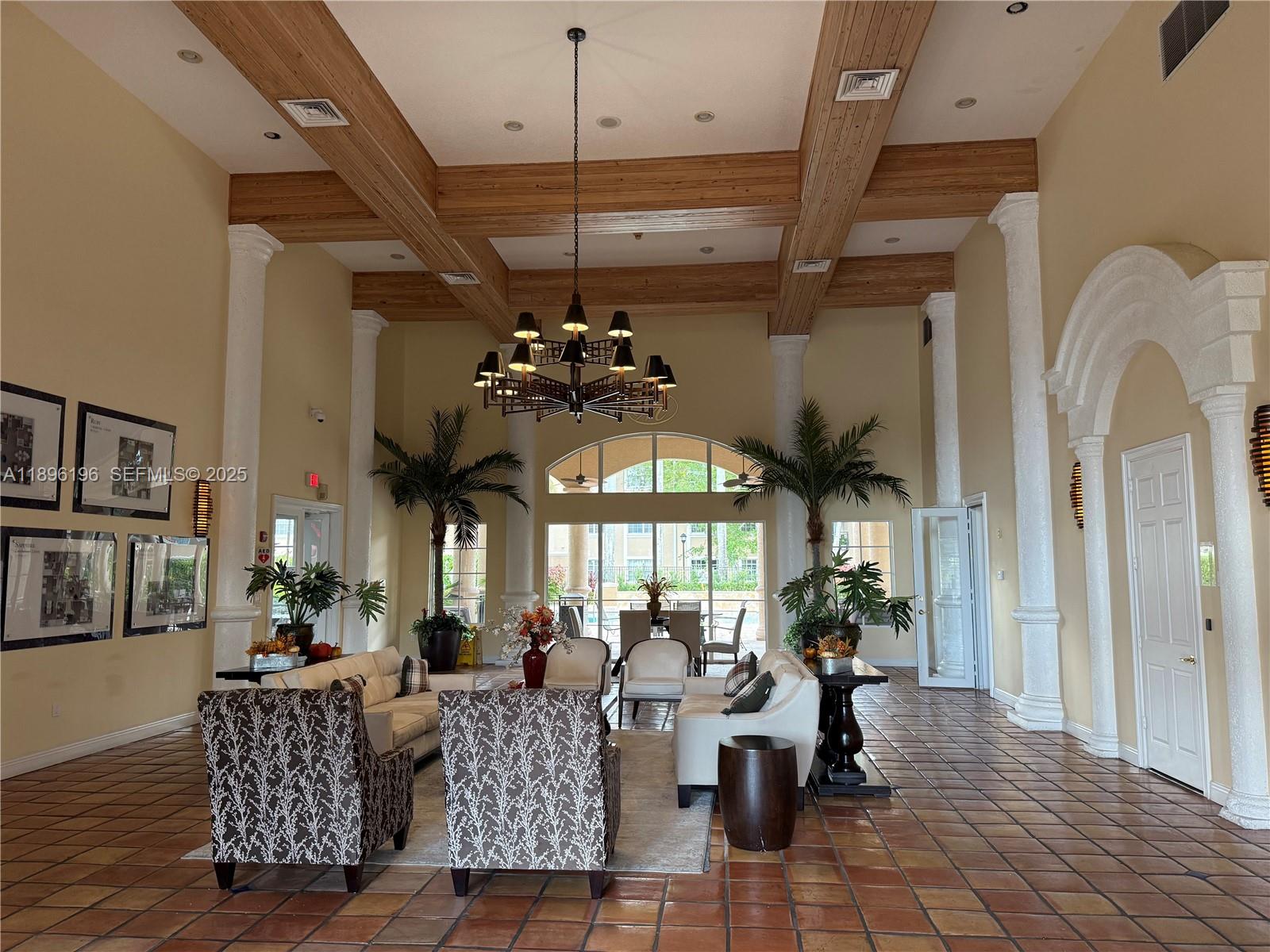 11601 Southwest 2nd Street, Unit 21301 Pembroke Pines, FL 33025 - Photo 15 of 21 a living room with lots of furniture and a chandelier