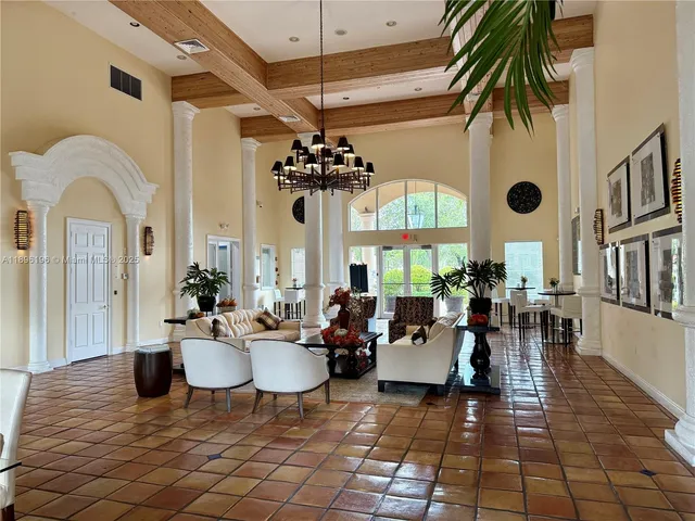a living room with fireplace furniture and a chandelier