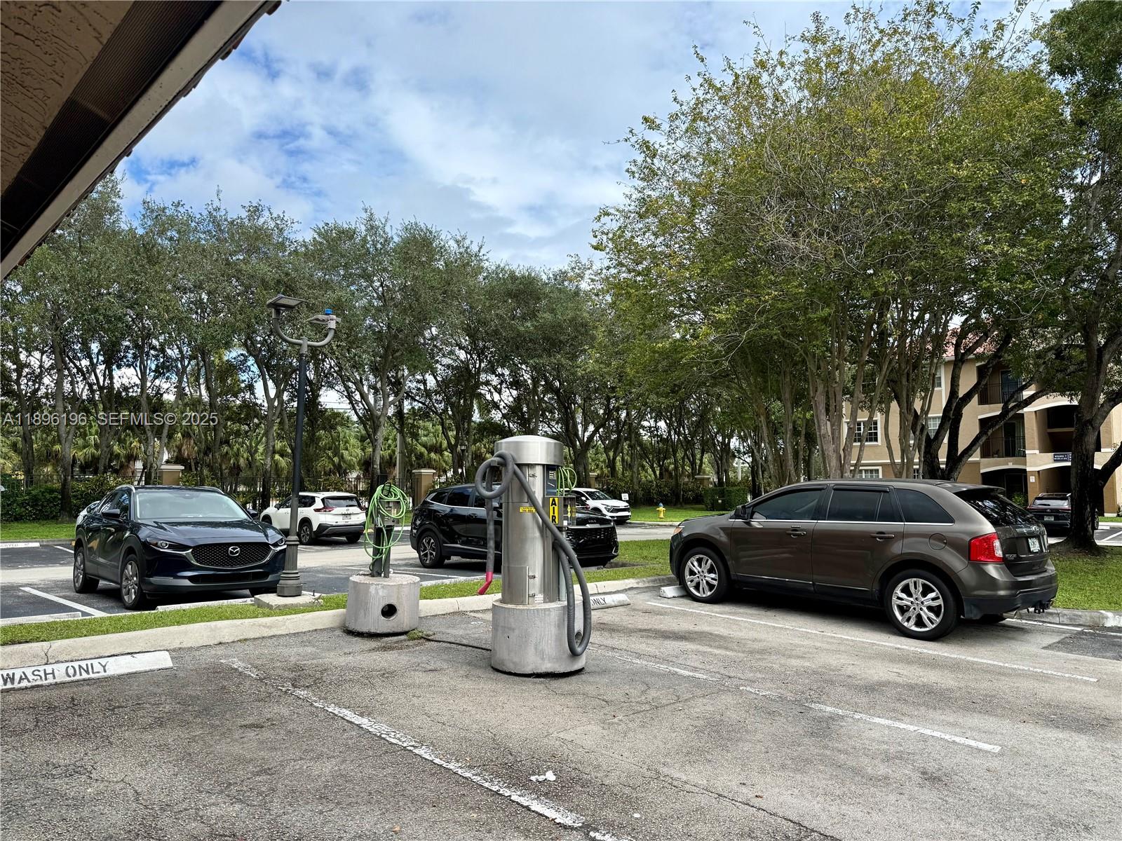 11601 Southwest 2nd Street, Unit 21301 Pembroke Pines, FL 33025 - Photo 20 of 21 a car parked in front of a house