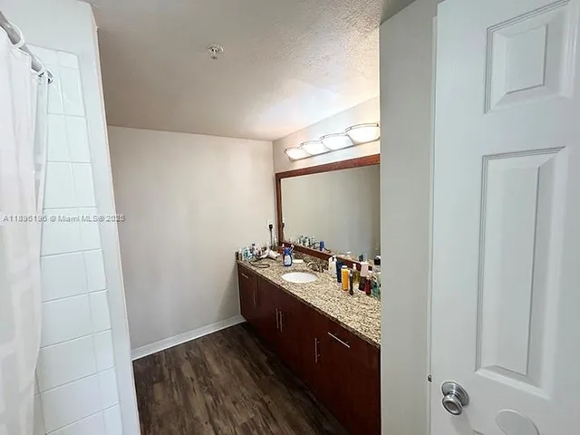 a bathroom with a double vanity sink and mirror
