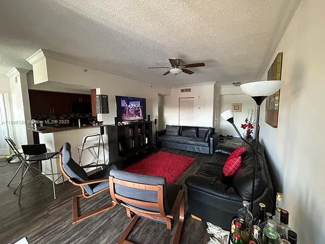 a room with furniture a flat screen tv and a window