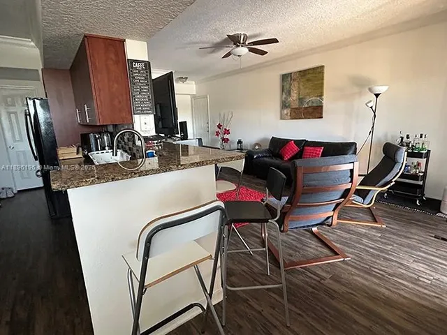 a living room with furniture a wooden floor and a sink