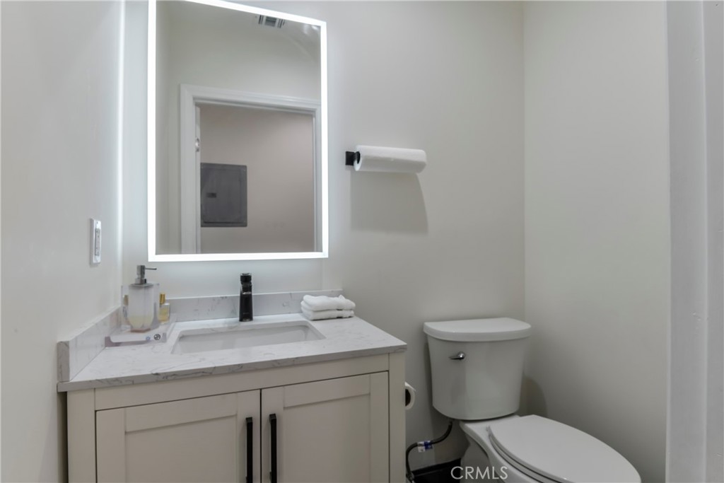 9728 Rhea Avenue Northridge, CA 91324 - Photo 19 of 36 a bathroom with a toilet sink and mirror