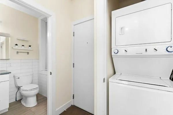 a white toilet sitting next to a bathroom sink