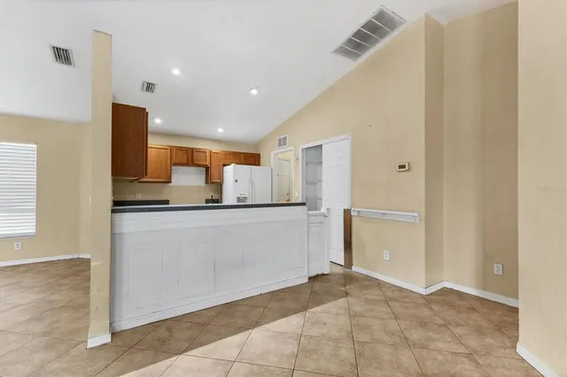 a view of kitchen with refrigerator cabinets and outdoor space