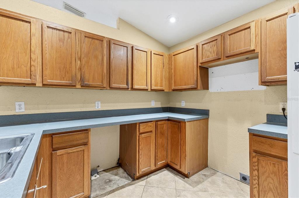 11619 Summit Rock Court Parrish, FL 34219 - Photo 15 of 36 a kitchen with stainless steel appliances granite countertop a refrigerator and cabinets