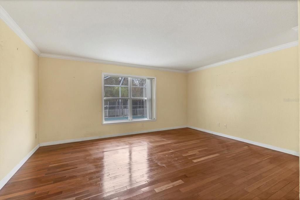 11619 Summit Rock Court Parrish, FL 34219 - Photo 17 of 36 an empty room with wooden floor and windows