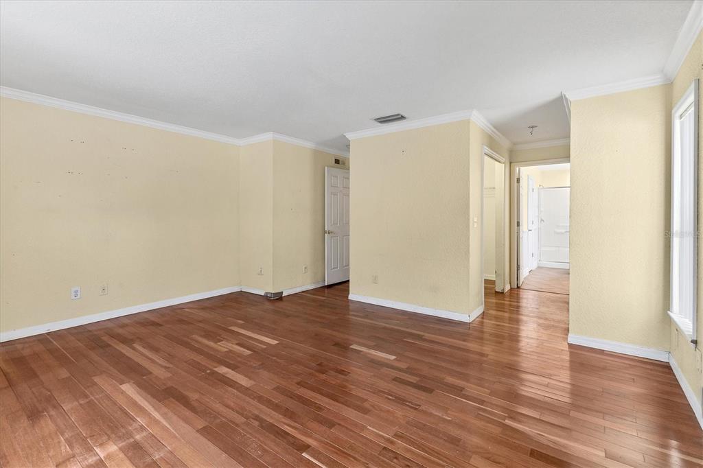 11619 Summit Rock Court Parrish, FL 34219 - Photo 18 of 36 a view of an empty room with wooden floor and a window