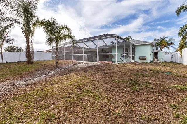 an aerial view of a swimming pool with outdoor seating