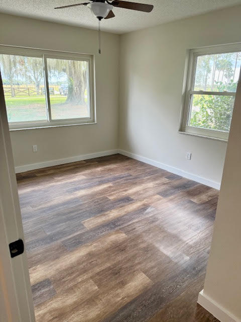 541 South Brocksmith Road Fort Pierce, FL 34945 - Photo 18 of 36 a view of an empty room with wooden floor and a window