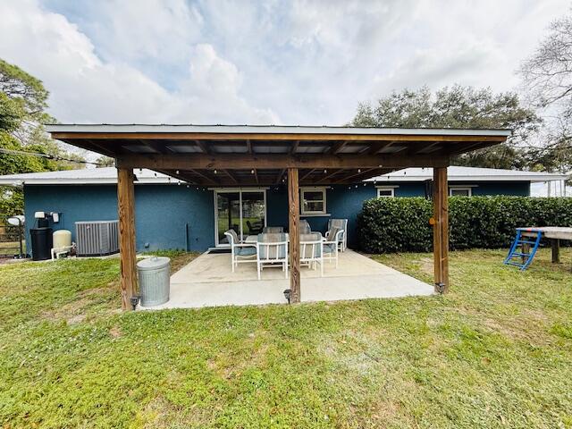 541 South Brocksmith Road Fort Pierce, FL 34945 - Photo 36 of 36 a view of a patio with table and chairs potted plants and large tree