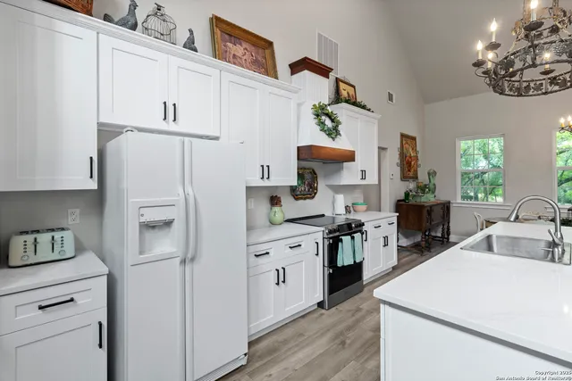 a dining room with furniture a window and a chandelier