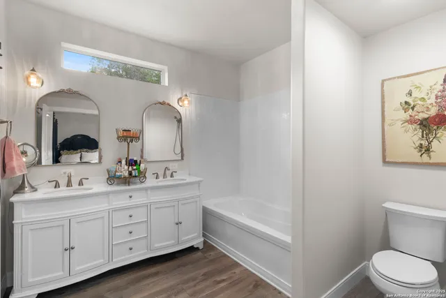 a bathroom with a double vanity sink and a mirror